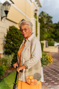 Portrait of smiling eldery women in orange dress