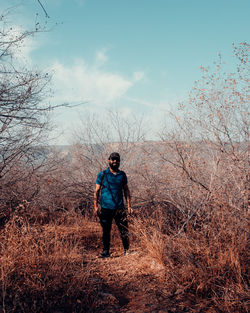 Full length of man standing on field against sky