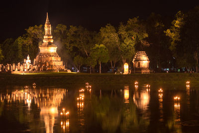 Reflection of illuminated building in water at night