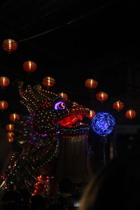 Low angle view of illuminated lanterns hanging at night