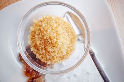 Directly above shot of brown sugar in container on table