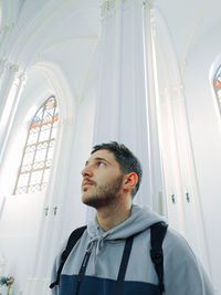 Low angle view of young man standing in church