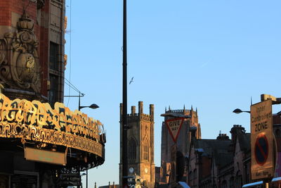 Low angle view of buildings against clear blue sky