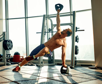 Full length of woman exercising in gym