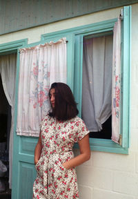 Woman standing by window