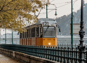 Yellow tram on tracks in street of budapest, hungary