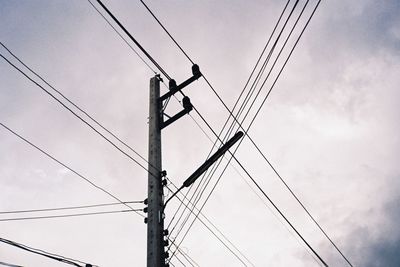 Low angle view of electricity pylon against sky