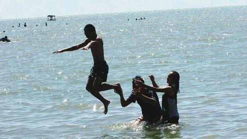 Friends standing on beach