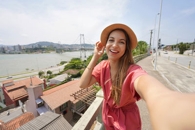 Self portrait of beautiful traveler woman visiting florianopolis, santa catarina, brazil