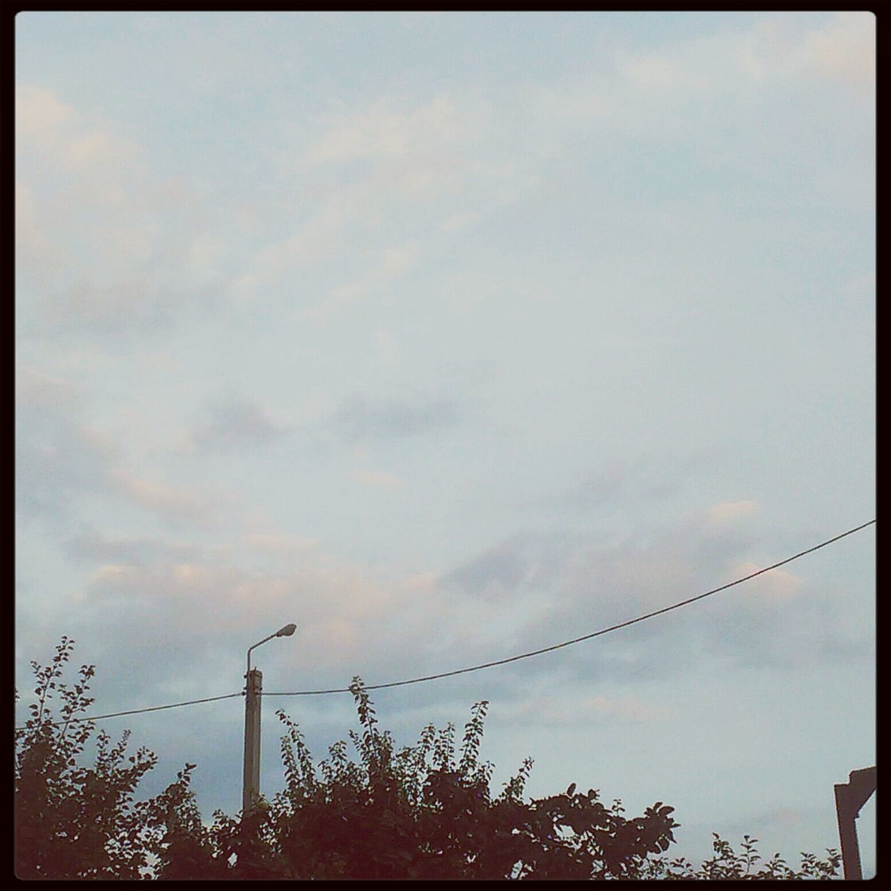 transfer print, low angle view, sky, auto post production filter, power line, cloud - sky, silhouette, electricity pylon, electricity, cloud, connection, cloudy, power supply, sunset, tree, nature, street light, cable, high section, outdoors