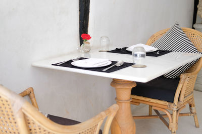 Empty chairs and tables on table in restaurant