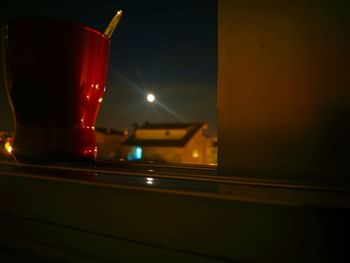 Close-up of wine glass on table at night