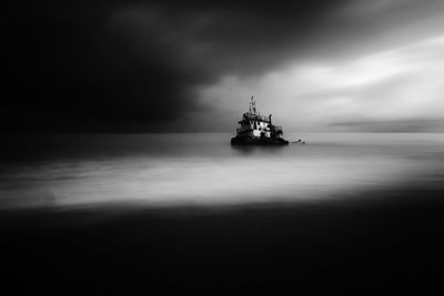 Boat sailing on sea against sky