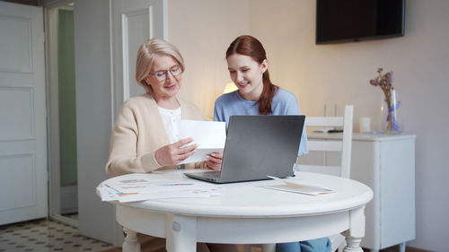 Young woman using laptop at home