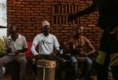 People sitting at market stall