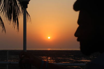 Silhouette of man at beach during sunset