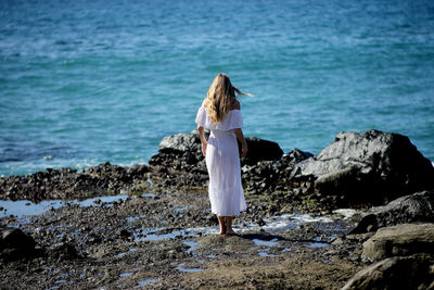 Rear view of woman looking at sea shore