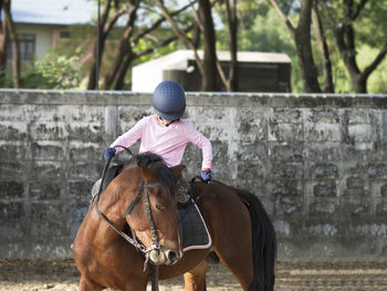 Full length of girl riding horse