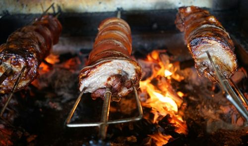 Close-up of pork belly roasting on barbecue