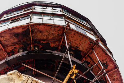 Low angle view of rusty tower against sky