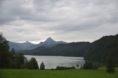 Scenic view of lake and mountains against sky