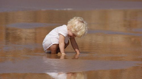 Child playing in shallow water