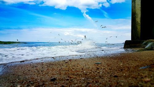 Scenic view of sea against cloudy sky