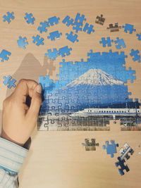 High angle view of hand holding paper