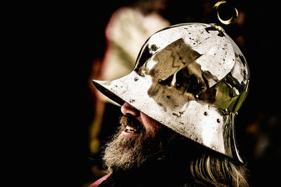 Close-up of bearded man wearing warrior helmet