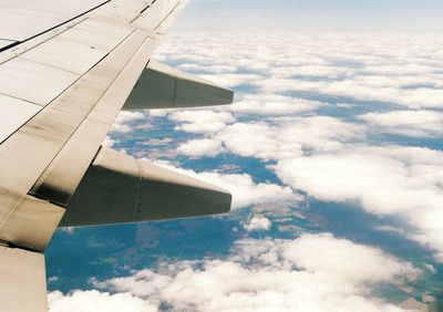 Cropped image of airplane flying over landscape