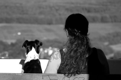 Rear view of woman sitting outdoors