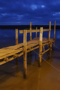 Pier over sea against sky at dusk