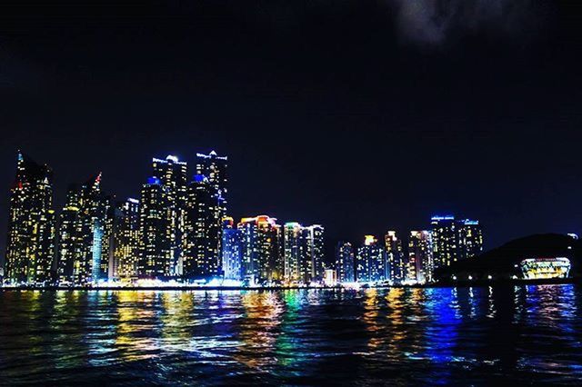 illuminated, night, city, building exterior, architecture, skyscraper, waterfront, water, built structure, cityscape, reflection, modern, urban skyline, office building, river, tall - high, tower, financial district, skyline, sky