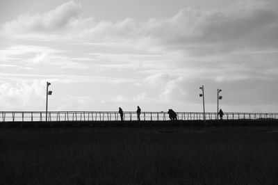 People on field against sky