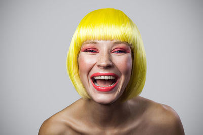 Portrait of young woman against white background