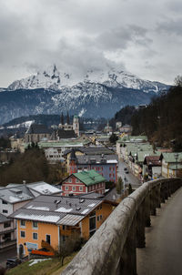 Houses in town against sky during winter