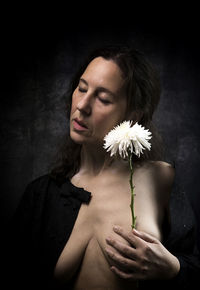 Woman in melancholic attitude with white chrysanthemum vi