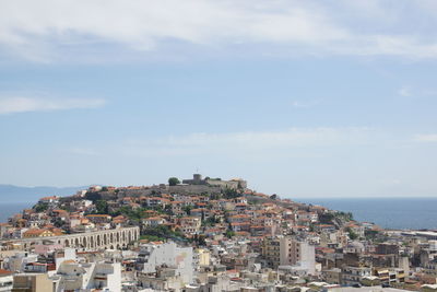 Townscape by sea against sky