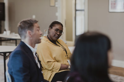 Businessman discussing with female colleagues at corporate office