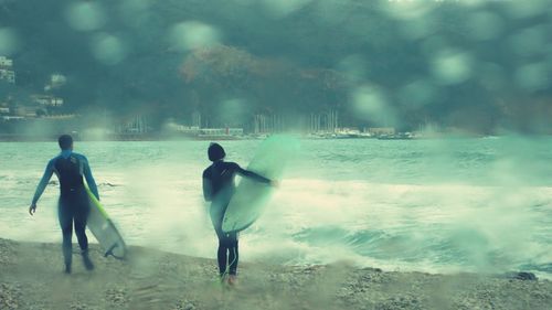 Full length of woman jumping on shore