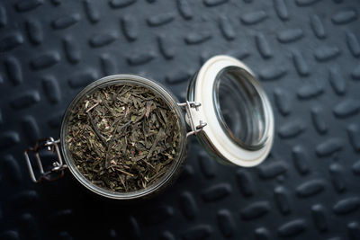 Directly above shot of herbs in jar on table