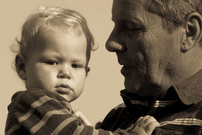 Close-up portrait of father and son