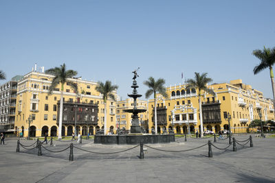 Buildings in city against clear sky