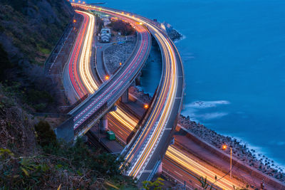 High angle view of light trails on highway at night