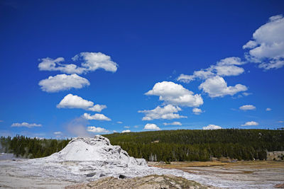 Scenic view of snowcapped mountains against blue sky