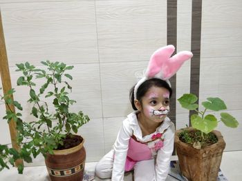 Cute girl in potted plant