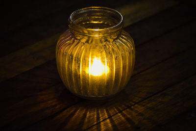 Close-up of illuminated lamp on table