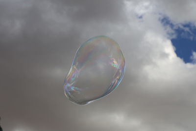 Close-up of bubbles against rainbow in sky