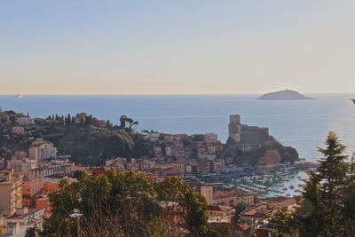 Panoramic shot of townscape by sea against sky