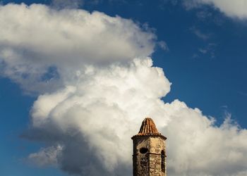 Low angle view of building against cloudy sky